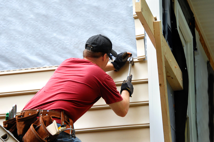 professional siding contractor doing siding repair